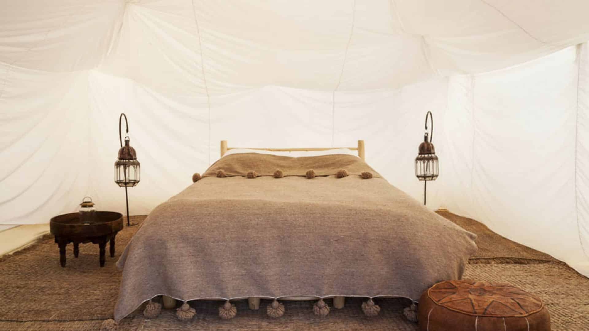 A bed in a tented room at Scarabeo Camp
