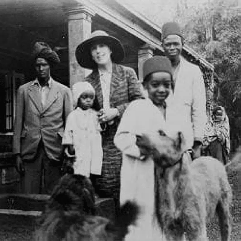 Karen Blixen with Kikuyu people and Wolfhounds at her farmhouse in Nairobi