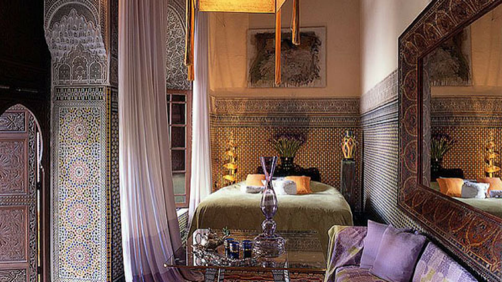 A lavender bedroom at Riad Enija with diaphanous curtains