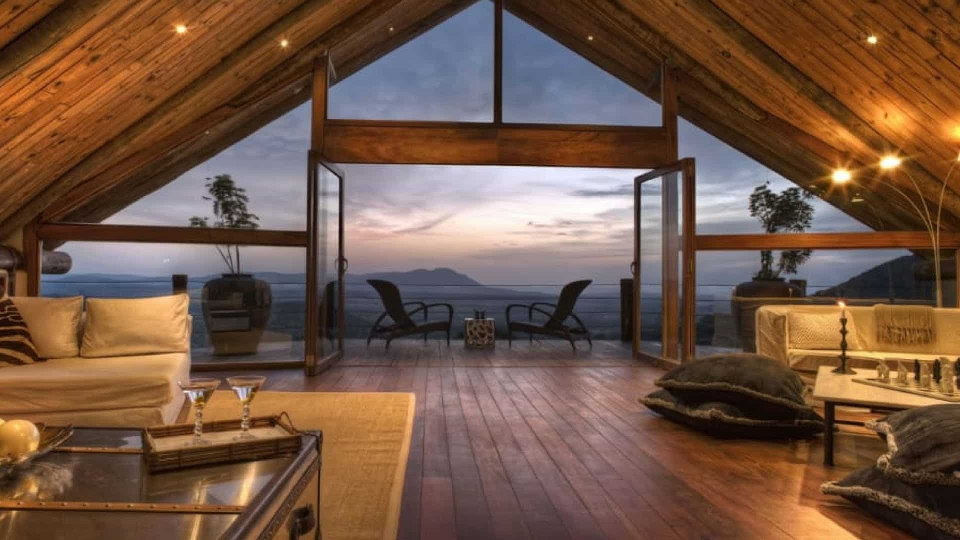 A room at the top of an A-frame with a view across African plains at Cottars 1920's