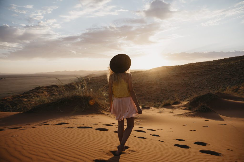 Namibia, Namib Desert, Namib Naukluft National Park, Sossusvlei, Woman Walking On Elim Dune At Sunse