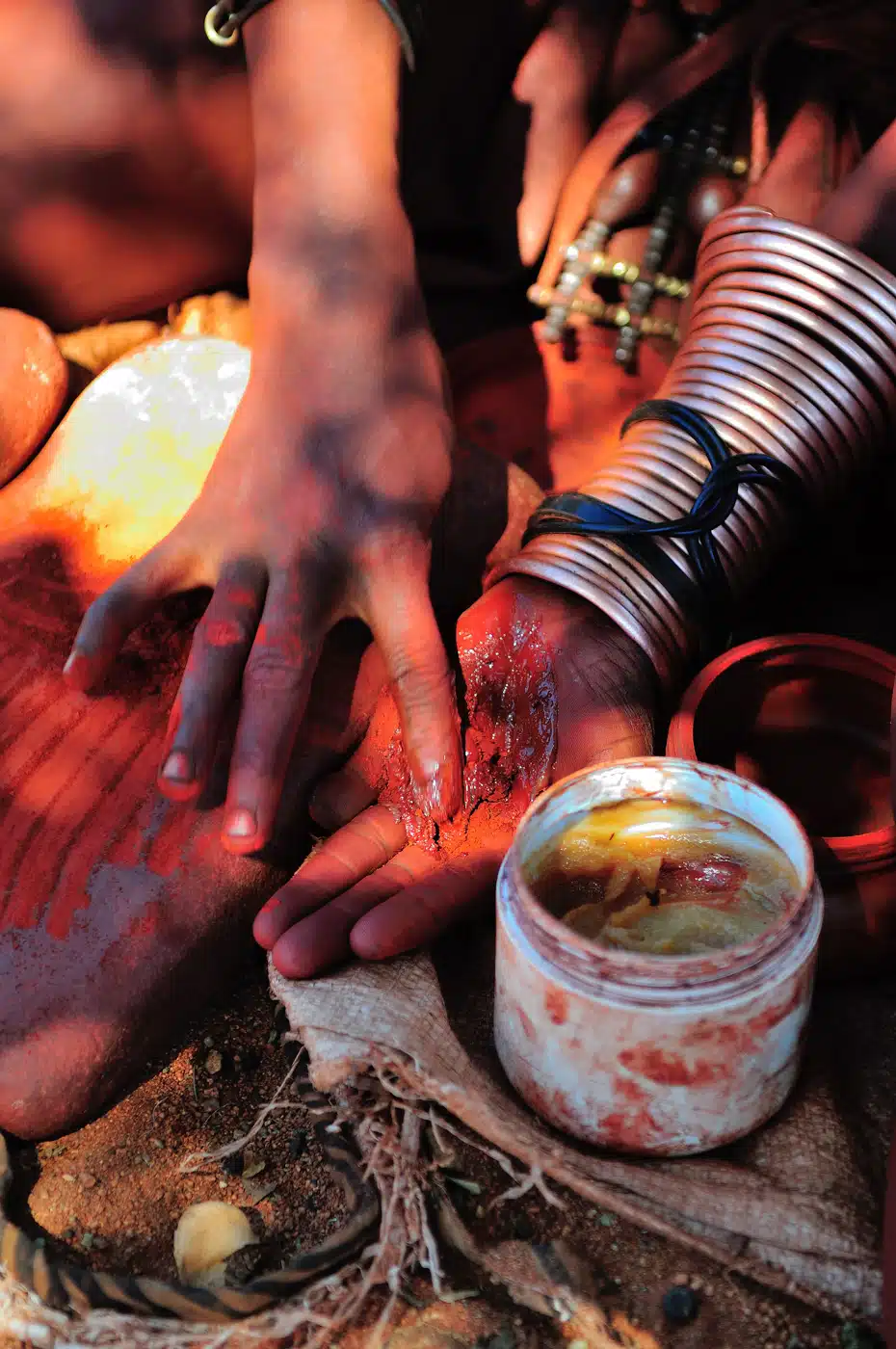 Himba Woman Mixing Red Ochre With Petroleum Jelly